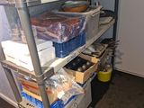 a metal shelf with various items on it in a room