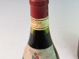 a bottle of wine sitting next to a bottle of wine