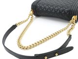 a close up of a black purse on a white background
