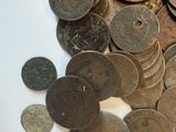 a pile of coins sitting on a table next to a pair of scissors