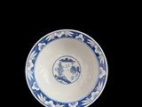 blue and white porcelain bowl with a bird on the rim