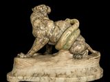 marble sculpture of a lion and a snake on a black background