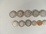 several different coins are arranged in a row on a white surface