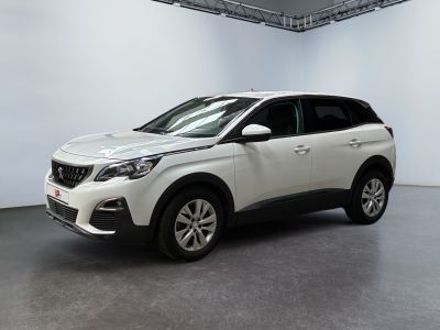 a white car is parked in a large room with a white wall