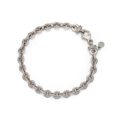a close up of a chain bracelet with a heart charm