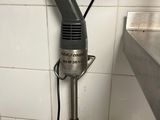 a hand mixer that is on the counter in the kitchen