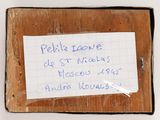 a piece of paper taped to a piece of wood with writing on it
