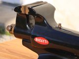 a black sewing machine sitting on a wooden table