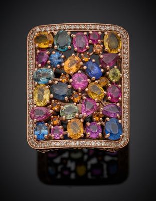 un gros plan d'une bague ornée de pierres multicolores et de diamants