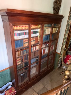 a book case with many books on it in a room