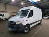 the white van is parked in a large warehouse with other vehicles