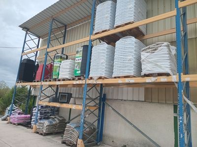 many stacks of items on the shelves outside of a building