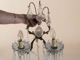 a person that is holding a crystal chandelier in their hand