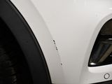 a close up of a car ' s front bumper with scratches on it