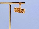 a gold plated necklace that has a sign on it
