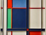 abstract painting of multicolored squares and rectangles in a white frame