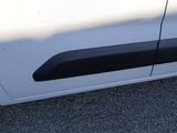 a white car with black trims parked in a parking lot