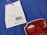 a close up of a blue shirt with a tag on it