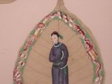 a picture of a woman on a leaf hanging on a wall