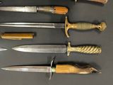 several different types of knives are lined up on a table