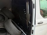a white van with a bunch of tires in the back