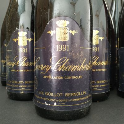 several bottles of wine are lined up on a table