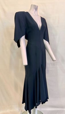 the back of a black dress on a mannequin base