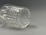 a clear glass cup sitting on a white surface