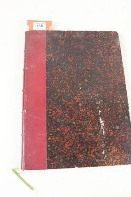 un livre à la couverture rouge posé sur une surface blanche