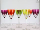 six wine glasses are lined up in a row on a table