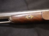 a close up of a knife with a wooden handle