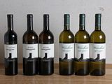 six bottles of wine are lined up in a row on a table