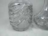 two glass vases sitting next to each other on a table