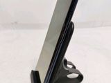 a cell phone that is on a stand on the table