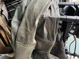 many pairs of boots that are sitting on top of a table