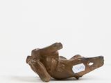 a small statue of a bird with a tag on it ' s neck