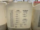 three jugs of liquid sitting on a counter