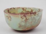 a green bowl with a floral design on it