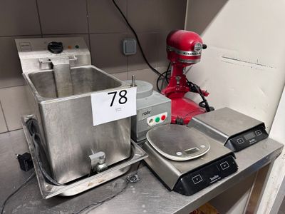 a red mixer sitting on a counter next to a red mixer