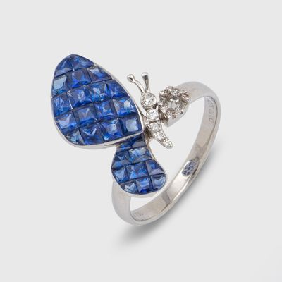 a close up of a ring with a butterfly on it