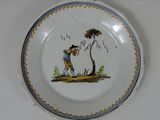 a plate with a picture of a man and a dog on it