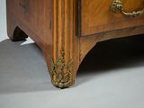 a wooden chest of drawers with brass handles on it