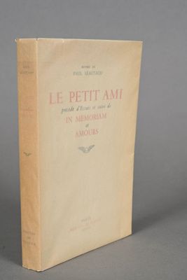 an old book sitting on top of a table on a gray surface