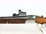 the rifle is on display on a white surface with a white background