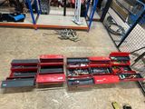 a lot of tools that are on the floor in the garage