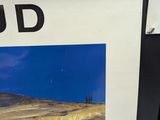 a poster with a picture of a farm in the middle of a field