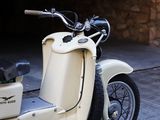 a scooter that is parked on the side of the street