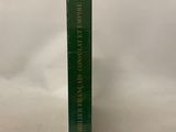 a green book sitting on top of a white table