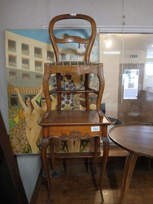 a chair and a table in a room with a painting on the wall