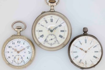 three different types of pocket watches are displayed on a white surface